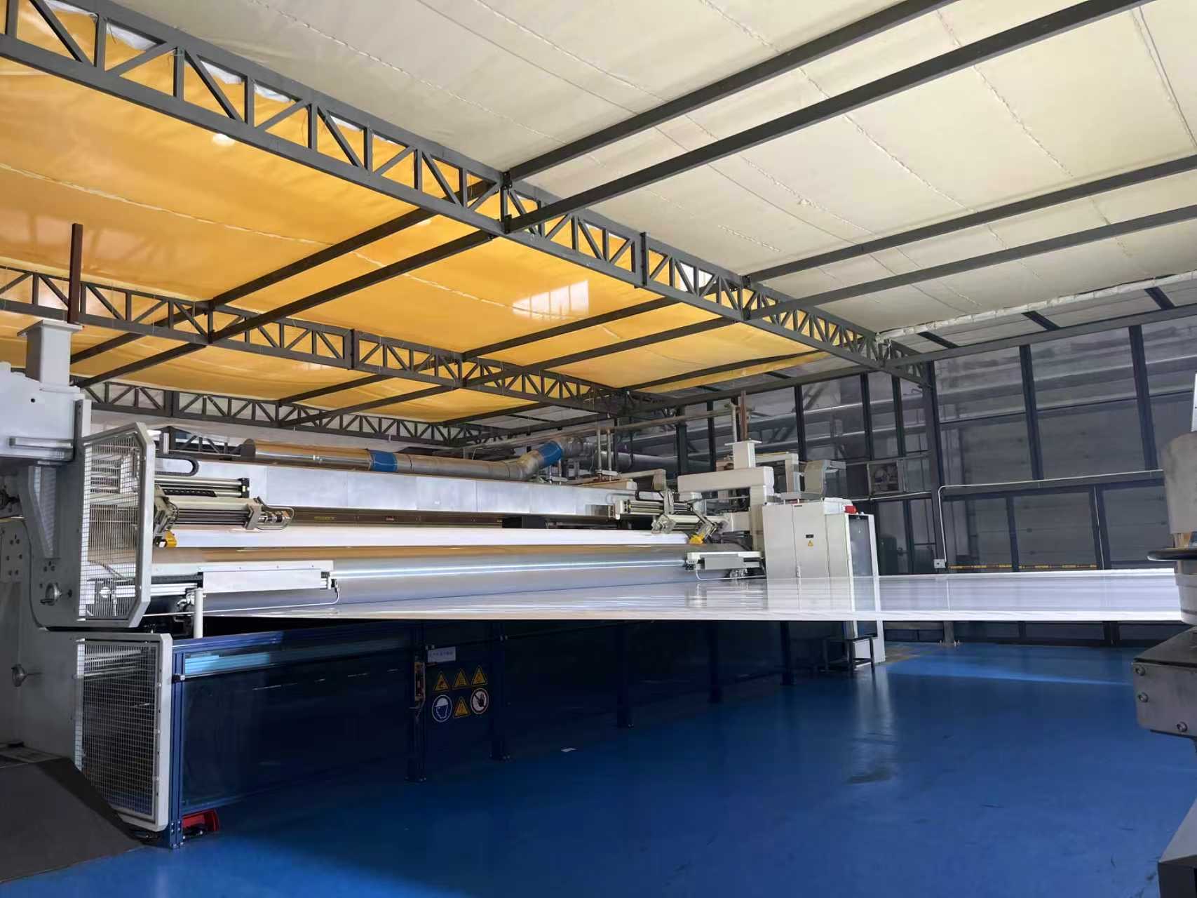 Adhesive material coating line